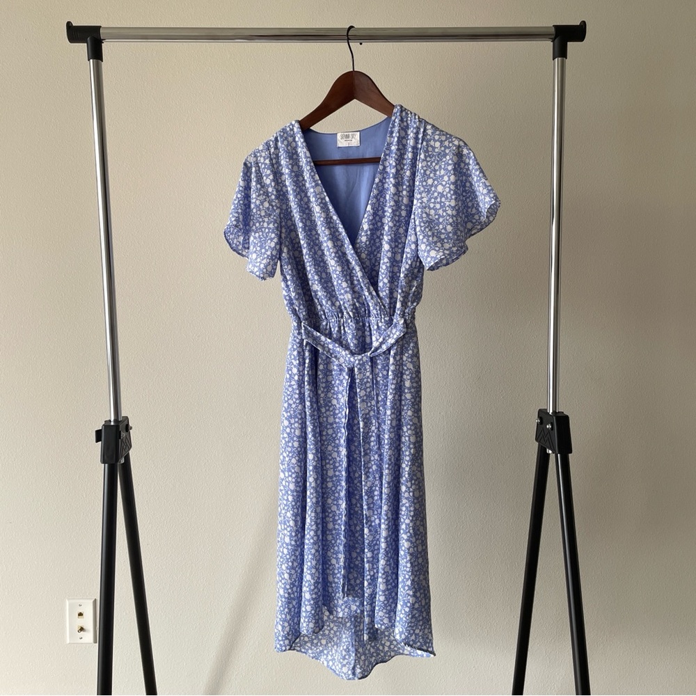 Sienna Sky blue floral flutter sleeve midi dress with a V-neck and waist tie.